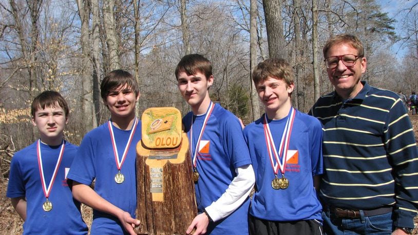 Mike Minium (right) with students holding the Ohio Valley School Orienteering Championship trophy. CONTRIBUTED