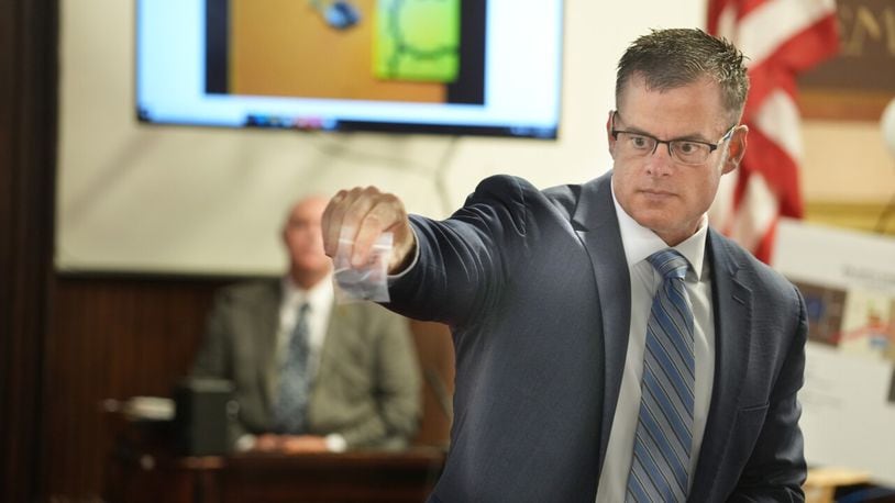 U.S. Attorney D. Andrew Wilson holds a bullet during testimony in the murder trial of George Wagner IV, 30, in Pike County Common Pleas Court in Waverly, Ohio, Friday, Sept 16, 2022. Behind Wilson is BCI agent Shane Harshaw. Wagner is charged with 22 counts, eight of them aggravated murder, in connection with the deaths of seven members of Pike County's Rhoden family and one future member on April 21-22, 2016. DORAL CHENOWETH/THE COLUMBUS DISPATCH