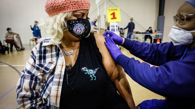 Christina Marshall, from Dayton, gets her COVID-19 booster shot at a Montgomery County Health vaccine clinic at Bethesda Temple Wednesday Feb. 16, 2022. JIM NOELKER/STAFF