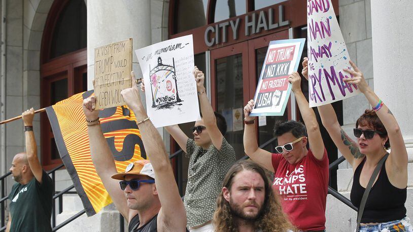 Protesters gathered at Dayton City Hall on Tuesday to voice their opposition to President Trump’s planned visit to Dayton on Wednesday. TY GREENLEES / STAFF