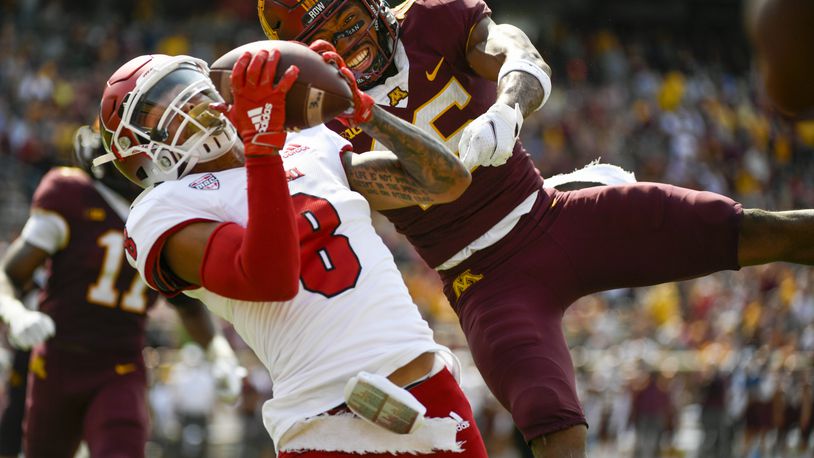 Miami-Ohio wide receiver Mac Hippenhammer (8) catches a 33-yard pass for a touchdown in front of Minnesota defensive back Coney Durr during the second half of an NCAA college football game on Saturday, Sept. 11, 2021, in Minneapolis. Minnesota won 31-26. (AP Photo/Craig Lassig)