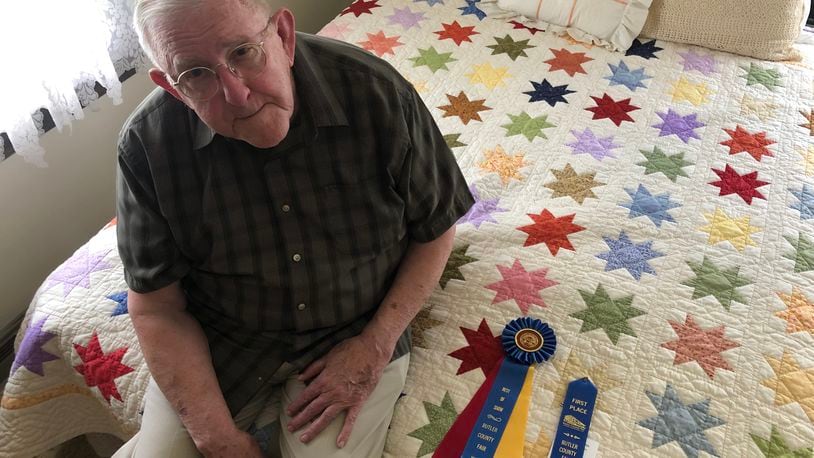Orville , 85, recently won "Best of Show" for this quilt at the Butler County Fair. RICK McCRABB/STAFF