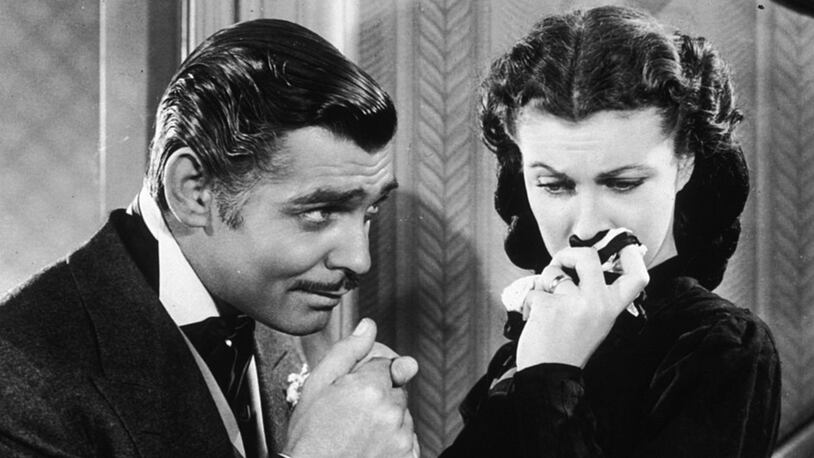 American actor Clark Gable (1901 - 1960) in his role as Rhett Butler kissing the hand of a tearful Scarlett O'Hara, played by Vivien Leigh in 'Gone With The Wind'.   (Photo by Hulton Archive/Getty Images)