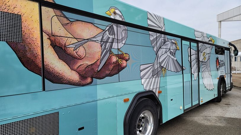 Three Butler County Regional Transit Authority buses have been wrapped in vinyl displaying StreetSpark murals that have been painted around Hamilton. This bus features the "Taking Flight" mural by artist Taylor Stone-Welch. NICK GRAHAM / STAFF