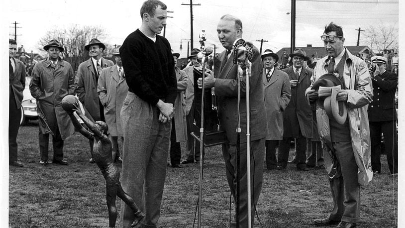 March 28, 1949 - Gene Baldwin, Captain of the 1949 State Basketball Champions, is presenting the state championship trophie to Hamilton City Schools Superintendent Walton Crewson. The presentation took place at the football athletic field on Fair Ave. & Dayton St. Others in the picture are Ed Griesinger, Booster President, Byron Hollinger, Reserve Basketball Coach and Mr. J. O. Fry, Hamilton High School Principal. (Behind Mr. Crewson) The photo is courtesy of Bernie Griesinger.