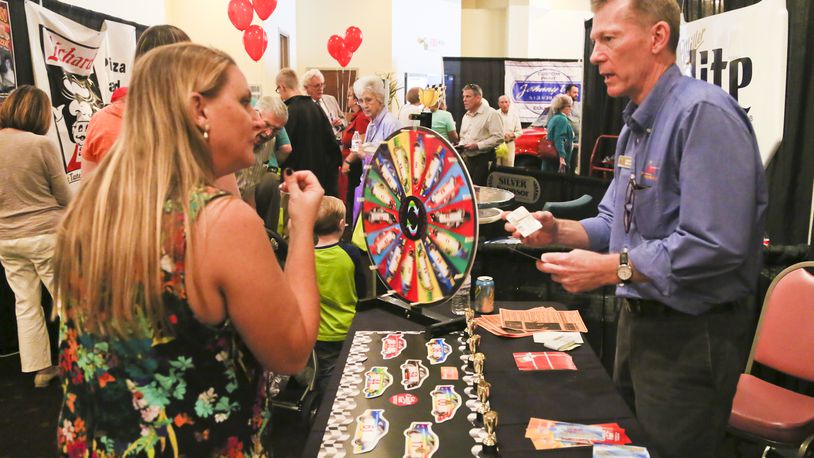 Tom Parker of The WEB Extreme Entertainment talks with Fairfield Twp. Trustee Shannon Hartkemeyer during a previous Fairfield Chamber of Commerce annual Business Showcase. This year’s event takes place Oct. 3. GREG LYNCH/STAFF