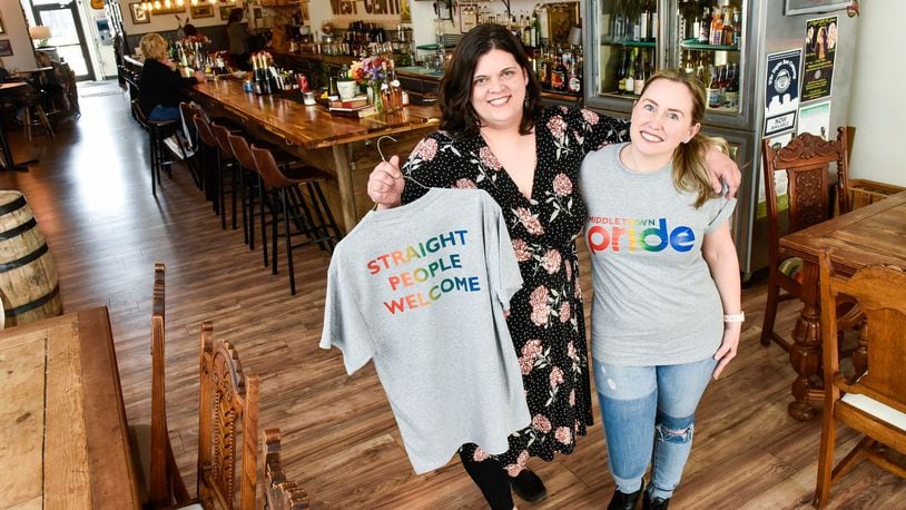 Melissa Kutzera, left, and Monica Nenni, owners of West Central Wine show off t-shirts being sold to raise money for the upcoming pride parade Tuesday, April 16 in Middletown. NICK GRAHAM/STAFF