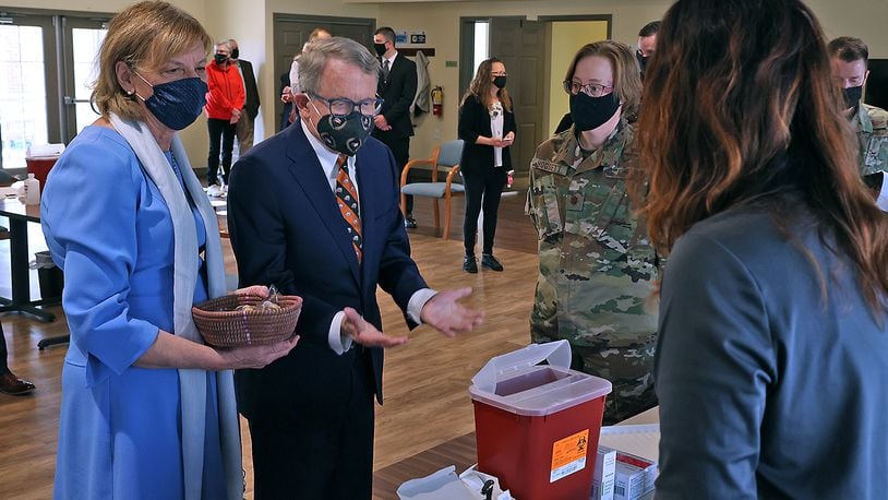 Ohio Governor Mike DeWine and his wife, Fran, talk to the nurses from the Clark County Combined Health District who were filling the COVID vaccination syringes during a visit to New Carlisle Senior Living. BILL LACKEY/STAFF