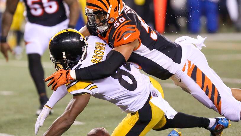 Cincinnati Bengals linebacker Jordan Evans defends a pass against Pittsburgh Steelers wide receiver Antonio Brown on Monday night. GREG LYNCH/STAFF PHOTO