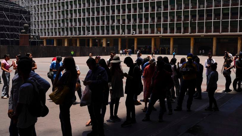People wait in line to register to vote in the upcoming presidential election in Caracas, Venezuela, Tuesday, April 16, 2024. Voters go to the polls on July 28th. (AP Photo/Ariana Cubillos)