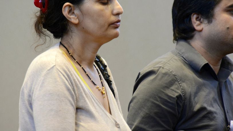 Subha Katel, 43, stands next to a court translator in Fairfield Municipal Court during a pre-trial hearing on Wednesday afternoon, Sept. 4, 2019. She is charged with negligent homicide in the shooting death of her husband, Tika Katel, 57. MICHAEL D. PITMAN/STAFF