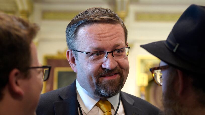 FILE - In this Tuesday, May 2, 2017 file photo, deputy assistant to President Trump, Sebastian Gorka, talks with people in the Treaty Room in the Eisenhower Executive Office Building on the White House complex in Washington during a ceremony commemorating Israeli Independence Day. White House national security aide Sebastian Gorka tells The Associated Press he has resigned from his position, Friday, Aug. 25, 2017.