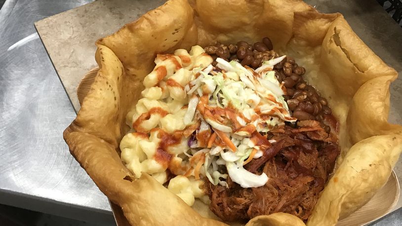 Smokehouse Bowl at Great American Ball Park: Imagine a large, bowl-shaped tortilla shell packed with pulled pork, coleslaw, and mac and cheese, topped with Montgomery Inn BBQ sauce. CONTRIBUTED