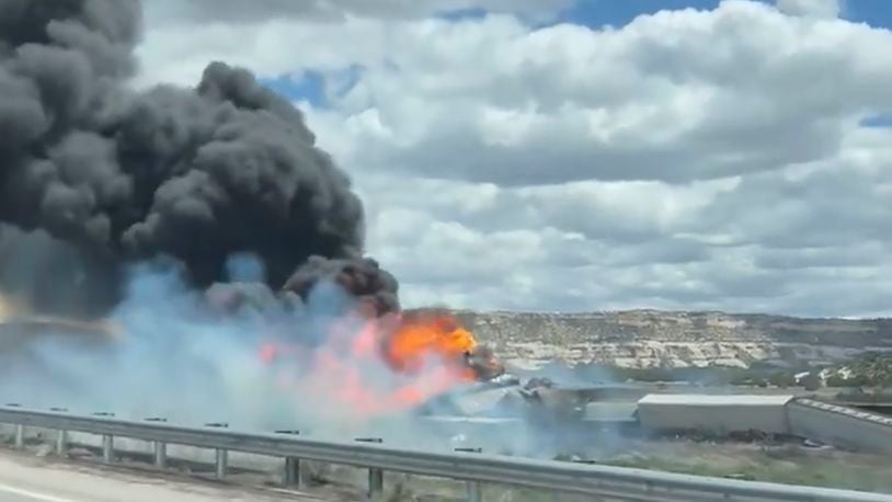 This frame grab taken from video provided by Bryan Wilson, shows a freight train carrying fuel that derailed and caught fire, Friday, April 26, 2024, near the New Mexico-Arizona state line, east of Lupton, Ariz. Authorities closed Interstate 40 in both directions in the area, directing trucks and motorists to alternate routes. (Bryan Wilson via AP)