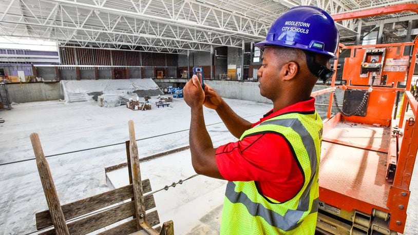 Middletown City Schools Superintendent Marlon Styles Jr. takes video of the new sports arena to post on social media during a tour of construction progress earlier this month at Middletown High School and the new Middletown Junior High School. NICK GRAHAM/STAFF