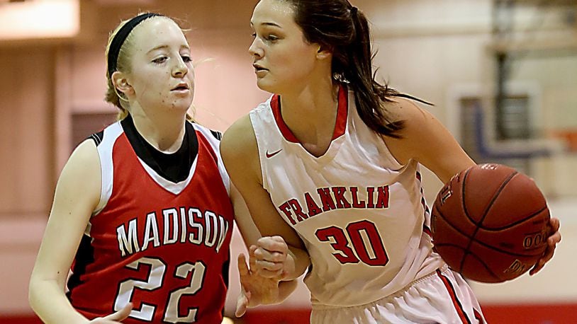 Franklin’s Layne Ferrell is covered by Madison’s Lily Campbell during the consolation game in the Miami University Middletown Holiday Tournament on Dec. 30, 2016. COX MEDIA FILE PHOTO
