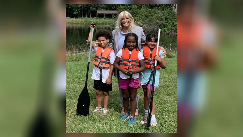 Ohio Rep. Sarah Carruthers was one of several donors who helped raise money to replace five stolen canoes, associated equipment and a trailer. Pictured is Carruthers with three of the YMCA campers at the Hughes Summer Camp at Camp Campbell Gard on Augspurger Road. PROVIDED