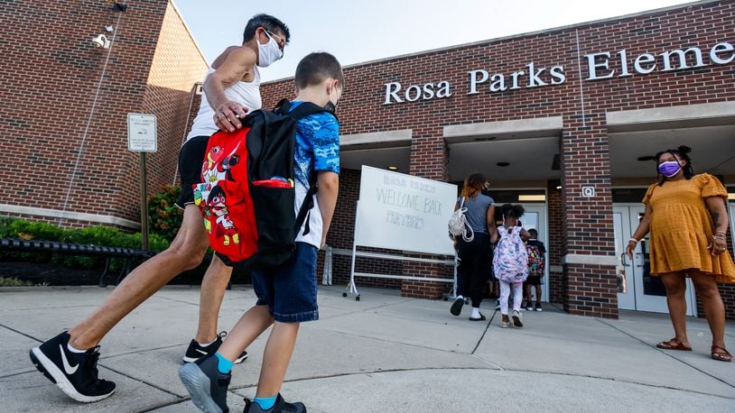 Danette Moore walks her grandson, Liam Lingenfelter, 6, in for the first day of school at Rosa Parks Elementary School Thursday, Aug. 12, 2021 in Middletown. NICK GRAHAM / STAFF