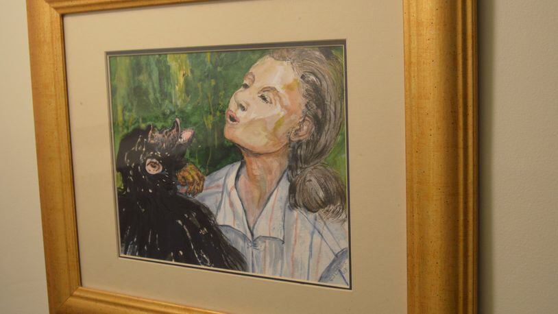 Hanging in in the stairwell leading to her basement is this water color of Jane Goodall painted by E.J. DeVore. CONTRIBUTED/BOB RATTERMAN