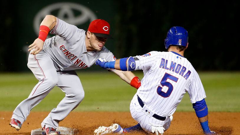 Cincinnati Reds second baseman Scooter Gennett tags out Chicago Cubs’ Albert Almora Jr. after Almora Jr. tried to stretch his hit to a double during the seventh inning of a baseball game Tuesday, Aug. 15, 2017, in Chicago. (AP Photo/Charles Rex Arbogast)