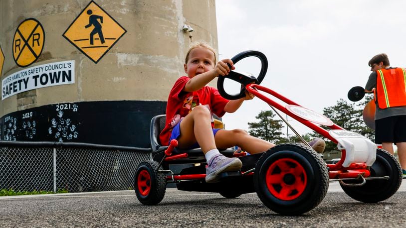 Annabelle Davis drives a pedal car around a simulated street course at Safety Town Monday, June 13, 2022, at Office Bob Gentry Park in Hamilton. Last year was the city of Hamilton's 50th year of Safety Town. The city of Fairfield is looking to launch its version of a Safety Town program either in 2023 or 2024. NICK GRAHAM/FILE