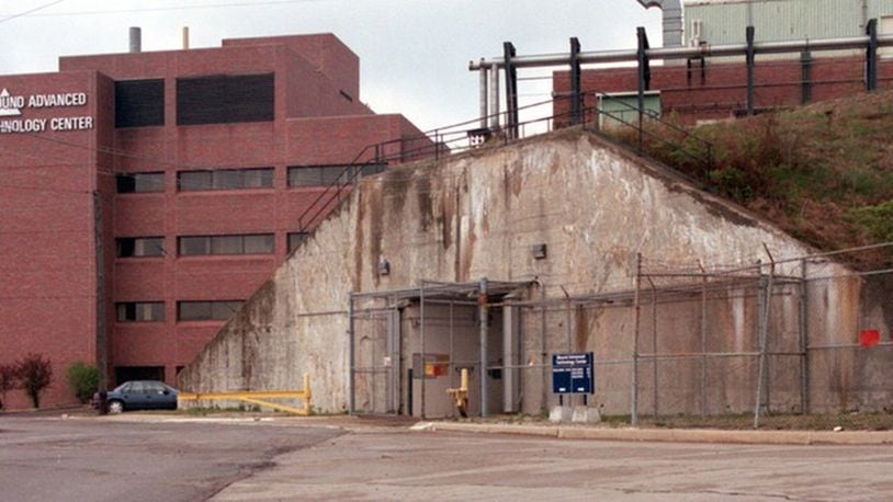 This photograph taken in 1997 shows one of the two entrances to T building on the grounds of Mound Lab in Miamisburg. The building, five stories underground (the newer building on the left is about five stories), is where Monsanto Chemical developed triggering device for the atomic bomb during World War II. This entrance is at the top of the secret installations that was built by carving out the earth on the other side of this hill, building the building and then packing the dirt back around it. FILE PHOTO