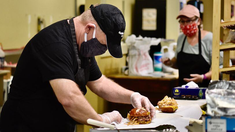 Alexander’s Market & Deli owner Les Rudisell prepares a sandwich at the eatery, which is one of 11 restaurants taking part in the inaugural Hamilton Restaurant Week. The event starts Tuesday, May 5, 2020, and runs through and including Friday, May 8, 2020. NICK GRAHAM/STAFF
