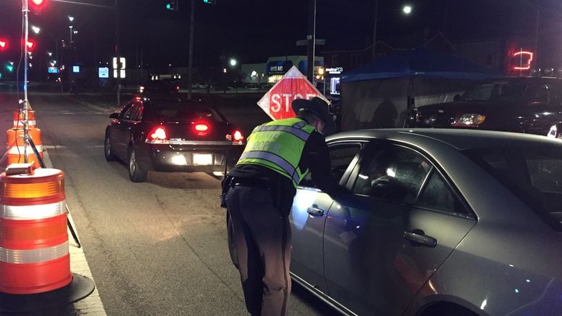 An Ohio State Highway Patrol trooper checks a driver during an OVI checkpoint at University Boulevard and First Avenue in Middletown on Jan. 17, 2020. The checkpoint was the latest organized by the Butler County OVI Task Force. The Middletown checkpoint was conducted by Middletown police, the highway patrol, and Butler County Sheriff’s deputies. ED RICHTER/STAFF