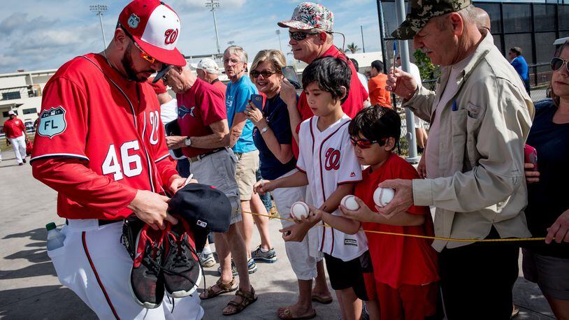 Washington Nationals pitcher Oliver Perez (46) signs hats and baseballs for fans during Spring Training at The Ballpark of the Palm Beaches in West Palm Beach, Fla., on Saturday, Feb. 18, 2017. (Michael Ares / The Palm Beach Post)
