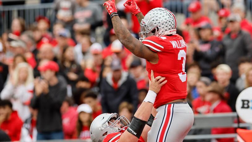 Ohio State running back Miyan Williams, top, celebrates his touchdown against Rutgers with teammate offensive lineman Matthew Jones during the first half of an NCAA college football game, Saturday, Oct. 1, 2022, in Columbus, Ohio. (AP Photo/Jay LaPrete)