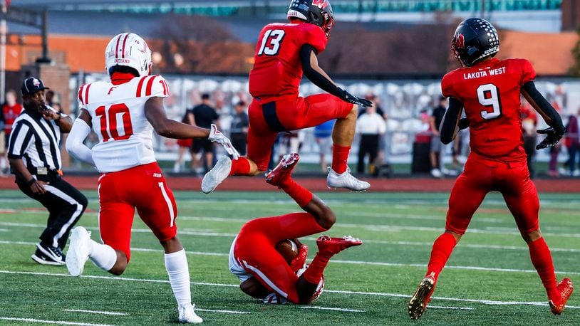 Lakota West's Ben Minich jumps over Fairfield's Mike Figgins during their football game Friday, Oct. 1, 2021 at Lakota West High School in West Chester Township. Lakota West won 42-10. NICK GRAHAM / STAFF