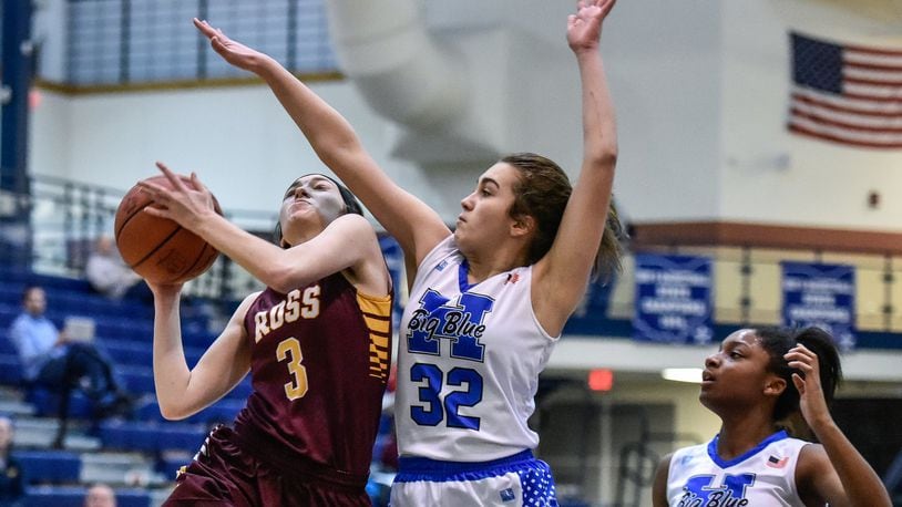 Julia Nunn of Ross puts up a shot while being defended by Hamilton’s Olivia Matthews during their game Jan. 8 at the Hamilton Athletic Center. The host Big Blue won 61-43. NICK GRAHAM/STAFF