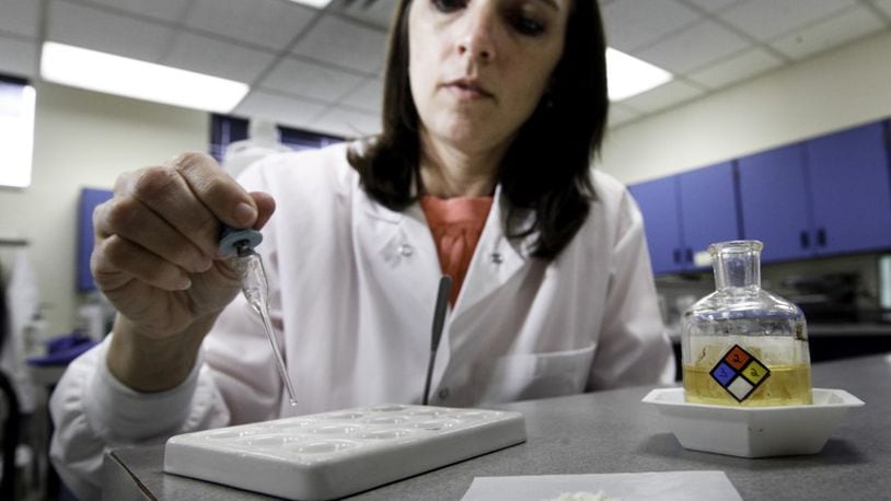 Brooke Ehlers, technical leader of the Miami Valley Regional Crime Laboratory’s Chemistry Section, tests a drug sample for fentanyl. The highly potent synthetic opioid — often cut with heroin or used alone — has been on the streets around Dayton since at least 2015.
