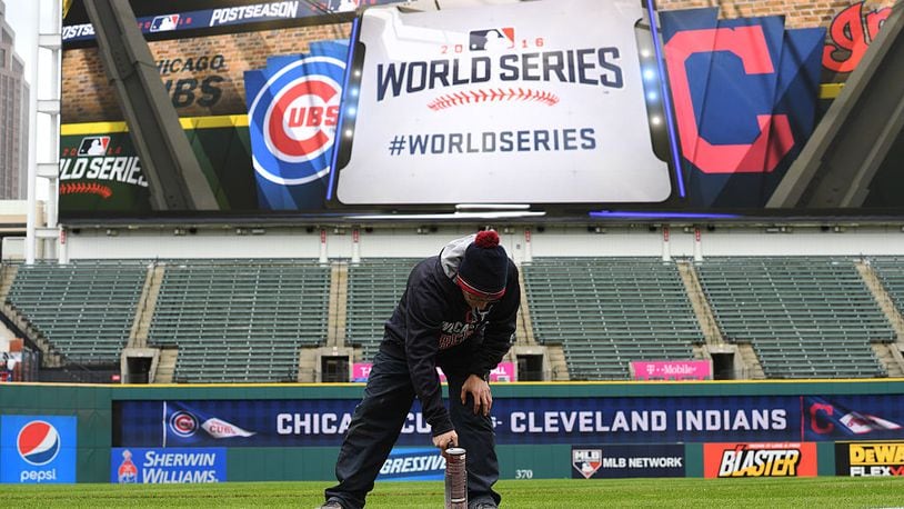 CLEVELAND, OH - OCTOBER 24: A member of the Cleveland Indians grounds crew paints the World Series logo on the field prior to Media Day at Progressive Field on October 24, 2016 in Cleveland, Ohio. (Photo by Jason Miller/Getty Images)