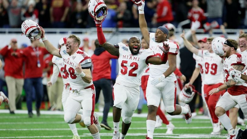 DETROIT, MI - DECEMBER 7: Defensive lineman Ryan Newton #48 of the Miami Redhawks celebrates along with defensive linemen Cam Turner #52 and Kobe Hilton #96 after a 26-21 win over the Central Michigan Chippewas to take the MAC Championship at Ford Field on December 7, 2019, in Detroit, Michigan. (Photo by Duane Burleson/Getty Images)