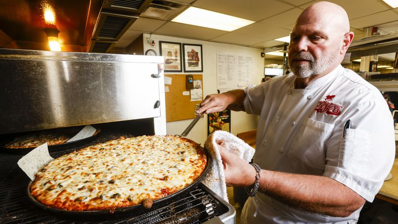 Chuck Vitale prepares a pizza order at Chester's Pizzeria on Dixie Highway in Hamilton Wednesday, June 21, 2023. NICK GRAHAM/STAFF 
