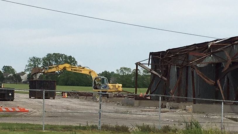 Crews demolish a hangar at Dayton-Wright Brothers Airport to make way for a $1 million, larger facility that will be able to house additional aircraft, according to the city of Dayton. Construction on the new hangar is expected to start in August. NICK BLIZZARD/STAFF