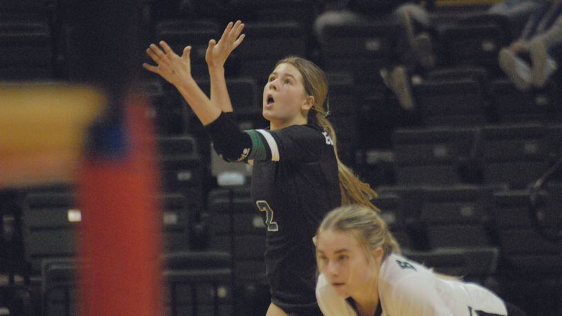 Badin's Alyvia Hegemann hits a serve as teammate Ellie Green looks on during Friday's Diviision II state semifinal match at the Nutter Center. Chris Vogt/CONTRIBUTED