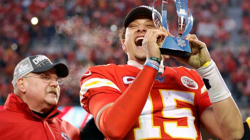Kansas City Chiefs quarterback Patrick Mahomes holds the Lamar Hunt Trophy as he celebrates winning the AFC Championship Game.