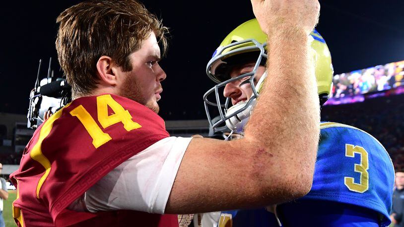 LOS ANGELES, CA - NOVEMBER 18:  Josh Rosen #3 of the UCLA Bruins and Sam Darnold #14 of the USC Trojans meet on the field after a 28-23 Trojan win at Los Angeles Memorial Coliseum on November 18, 2017 in Los Angeles, California.  (Photo by Harry How/Getty Images)