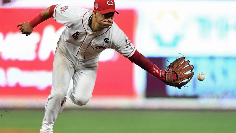 CINCINNATI, OH - JULY 19:  Jose Iglesias #4 of the Cincinnati Reds tosses the ball to second base after fielding a ground ball in the sixth inning against the St. Louis Cardinals at Great American Ball Park on July 19, 2019 in Cincinnati, Ohio. All runners were safe on the play.  (Photo by Jamie Sabau/Getty Images)