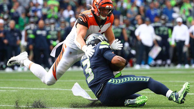 SEATTLE, WASHINGTON - SEPTEMBER 08: Russell Wilson #3 of the Seattle Seahawks is tackled by Sam Hubbard #94 of the Cincinnati Bengals in the fourth quarter during their game at CenturyLink Field on September 08, 2019 in Seattle, Washington. (Photo by Abbie Parr/Getty Images)