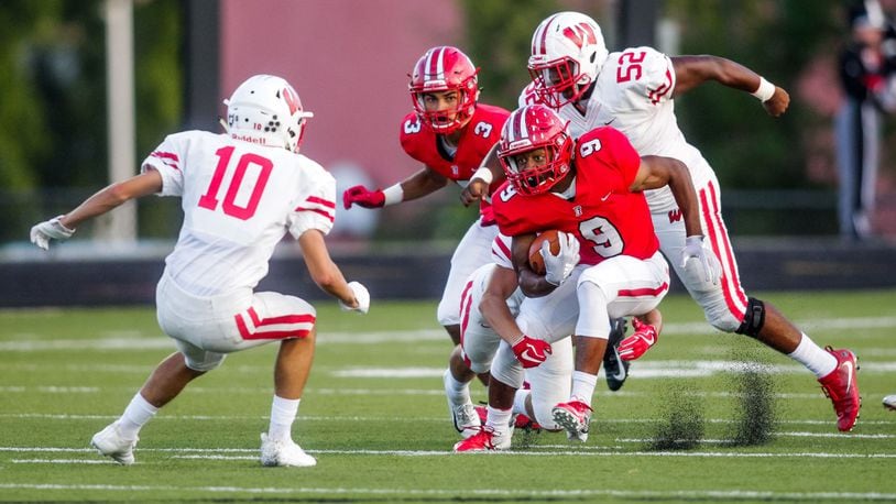 Fairfield’s JuTahn McClain cuts between Lakota West defenders Silas Walters (10) and Ladonnis Griffin (52) during Friday night’s game at Fairfield Stadium. McCain rushed for 140 yards and three touchdowns in the Indians’ 37-3 win. NICK GRAHAM/STAFF