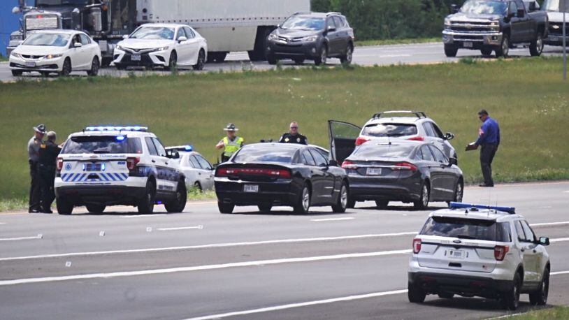 Investigators respond to a deadly shooting on Interstate 75 south near Austin Boulevard in Miami Twp. that happened around noon Monday, July 27, 2020. MARSHALL GORBY / STAFF