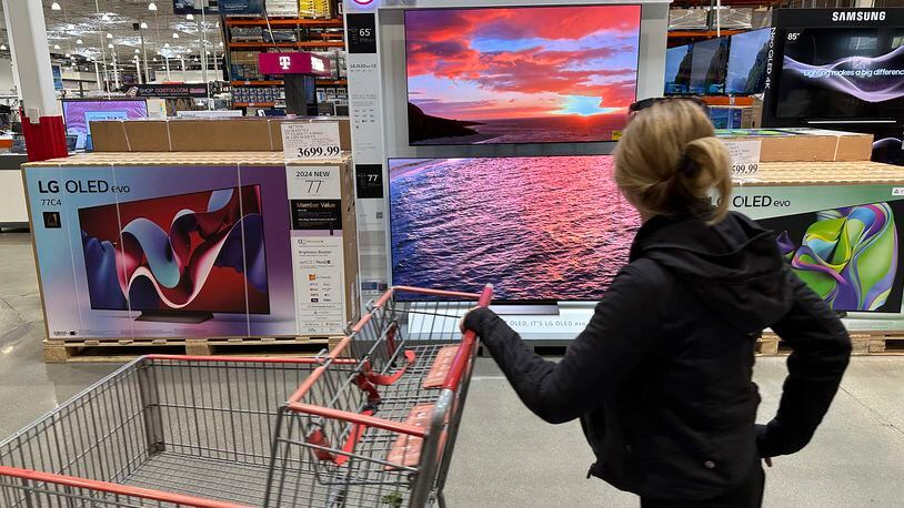 FILE - A shopper passes a display of televisions at a Costco warehouse on April 29, 2024, in Lone Tree, Colo. On Friday May 10, 2024, the University of Michigan releases its preliminary reading of consumer sentiment for May. (AP Photo/David Zalubowski, File)