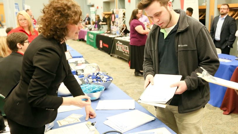 In this 2016 photo, Mark Kehl of Cincinnati talks with Joy Frey of Barclaycard during the Miami University Regional Butler County Job Fair. This year’s job fair will take place Wednesday, April 12. GREG LYNCH / STAFF