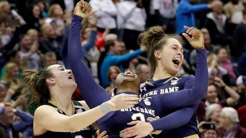 Notre Dame's Arike Ogunbowale, center, celebrates with teammates Marina Mabrey, left, and Kathryn Westbeld after defeating Mississippi State in the final of the women's NCAA Final Four college basketball tournament, Sunday, April 1, 2018, in Columbus, Ohio. Notre Dame won 61-58. (AP Photo/Tony Dejak)