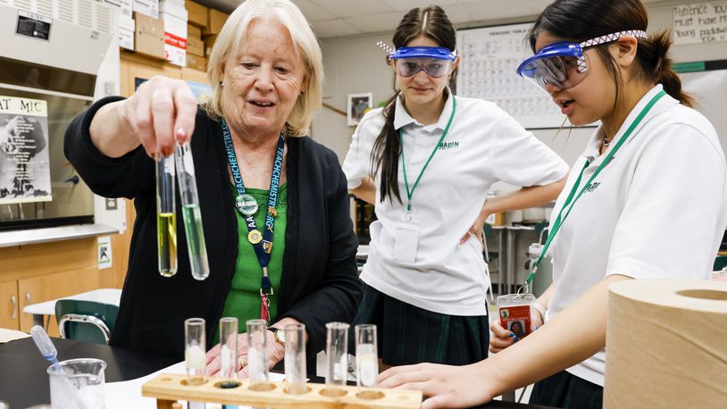 Badin High School chemistry teacher Teresa Heinrich helps Molly Black, middle, and Gracie Luong, right, with a lab project Friday, May 12, 2023 in Hamilton. Heinrich is Badin's most veteran teacher and is finishing her 43rd year of teaching at Badin. NICK GRAHAM/STAFF
