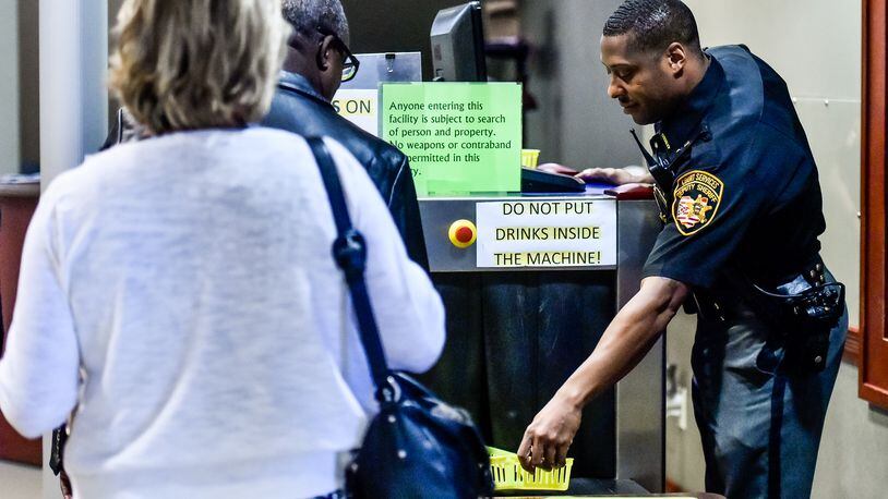 Leroy Cardwell, a Court Services deputy with the Butler County Sheriff’s Office, checks the security screening station as visitors enter Butler County Common Pleas Court Thursday, Aug. 24 at the Government Services Building on High Street in Hamilton. NICK GRAHAM/STAFF