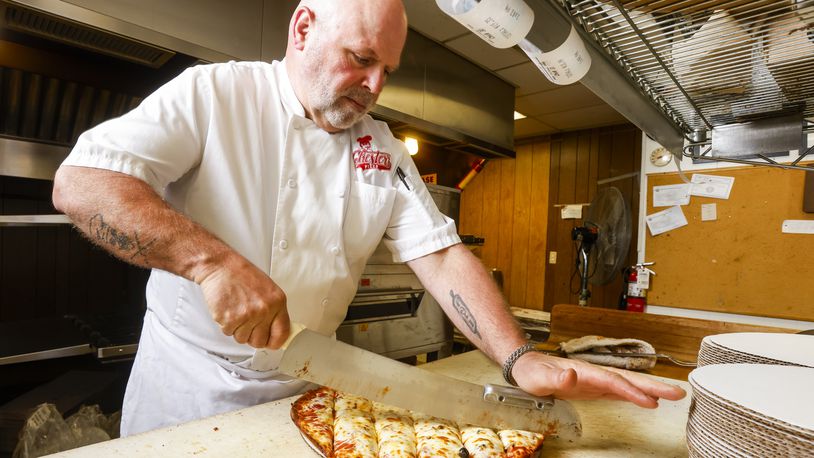 Chuck Vitale prepares a pizza order at Chester's Pizzeria on Dixie Highway in Hamilton this past summer. The pizza restaurant on Dixie Highway turned 70 years old on April 1, 2024, and was named Best Pizza in the 2023 Best of Butler County contest presented by the Journal-News. NICK GRAHAM/FILE